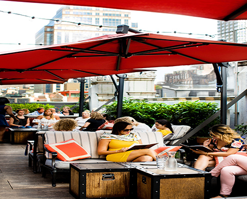 People sitting outside at Refinery Rooftop